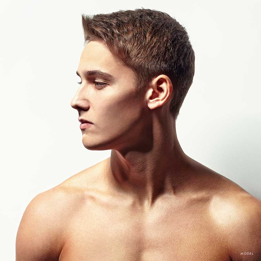 Sideview headshot of a younger male model