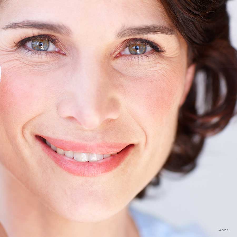 Headshot of a middle aged female model smiling